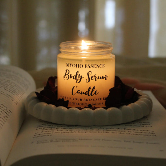 Lit Body Serum Candle with melted serum ready for application